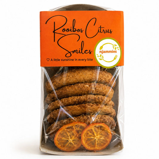 Njammies Rooibos Citrus Smiles cookies in their orange-labelled pack with dried citrus slices.