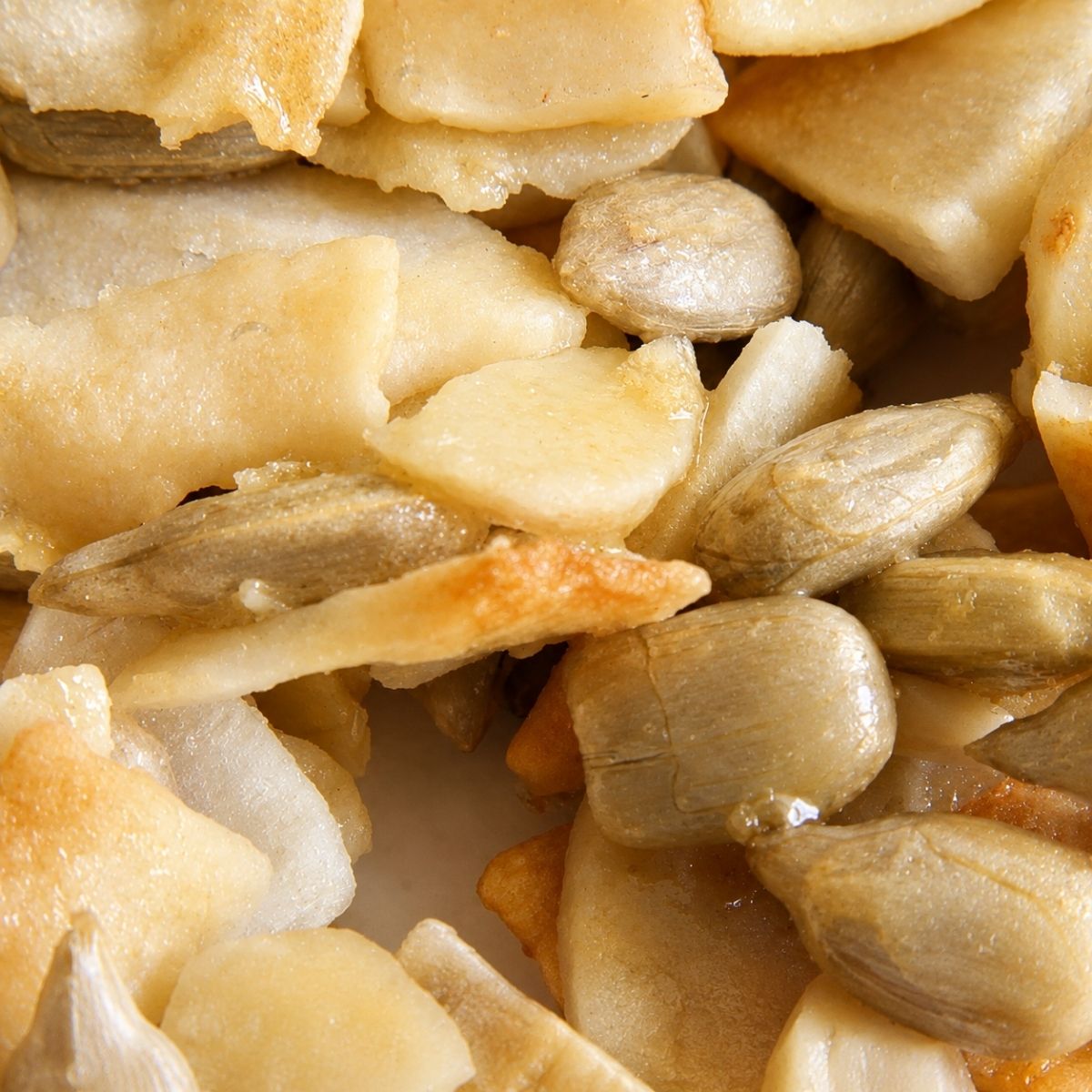 Close-up of crunchy Njammies Coconut Almond Rocks with coconut, almonds and sunflower seeds