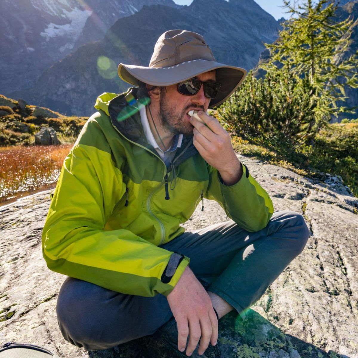 Hiker enjoying Njammies Fruit String Mix during an outdoor adventure.