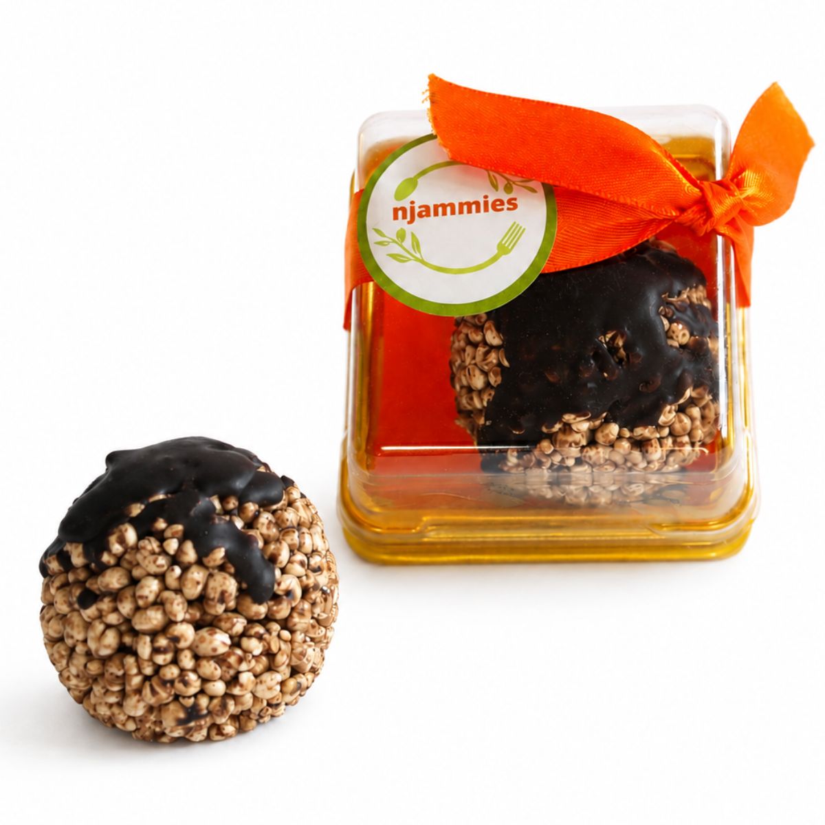 Close-up of Njammies Millet Moon Balls showing puffed millet drizzled with chocolate.