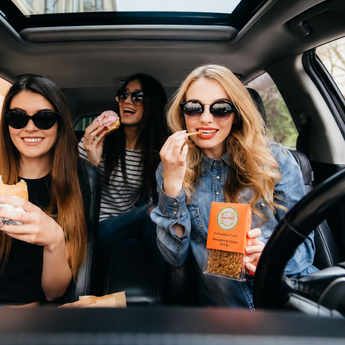 Friends enjoying Njammies Fruit String Mix together during a road trip.