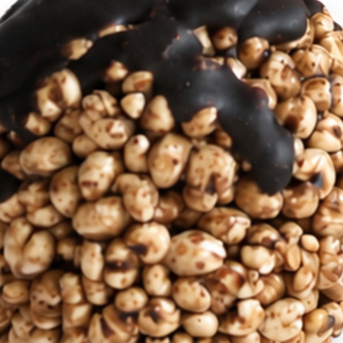 Close-up of Njammies Millet Moon Balls showing puffed millet drizzled with chocolate.