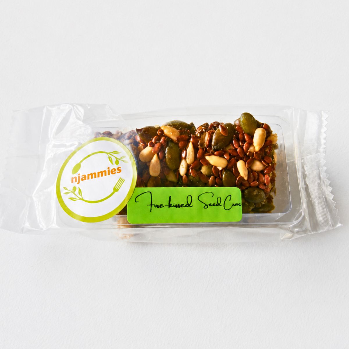 Fire-kissed Seed Crackers single portion packed in a transparent container